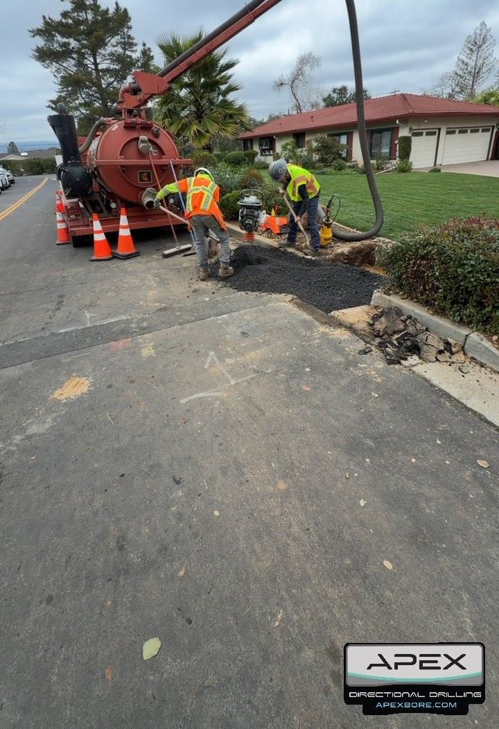 Crew placing a temporary asphalt patch