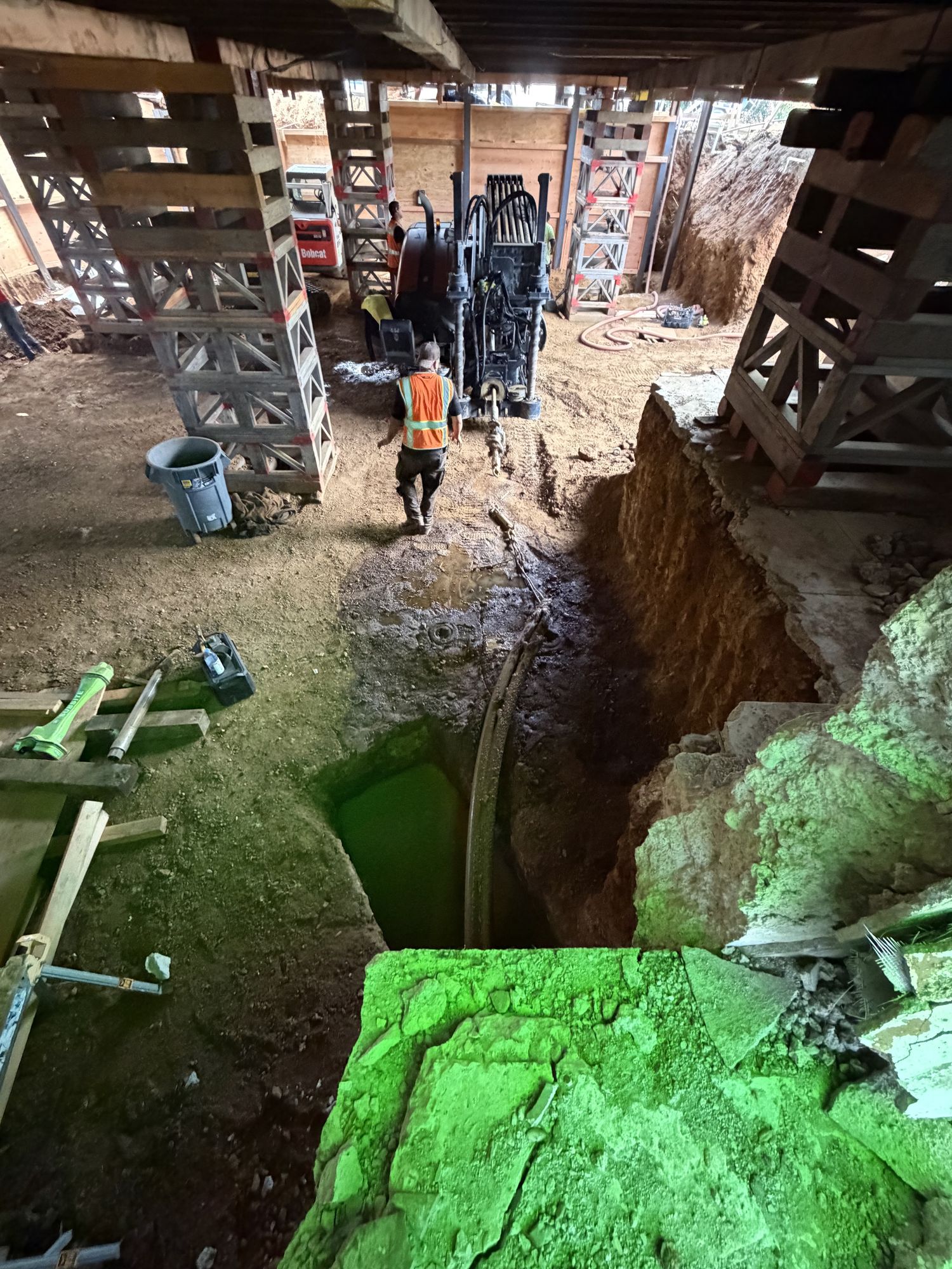 Bore pit in the basement with the drill rig behind it