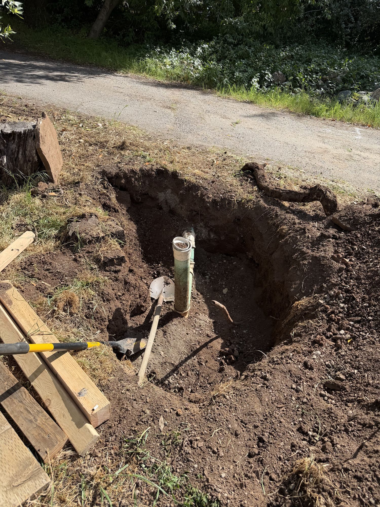 Conduit stub in a pit next to the driveway