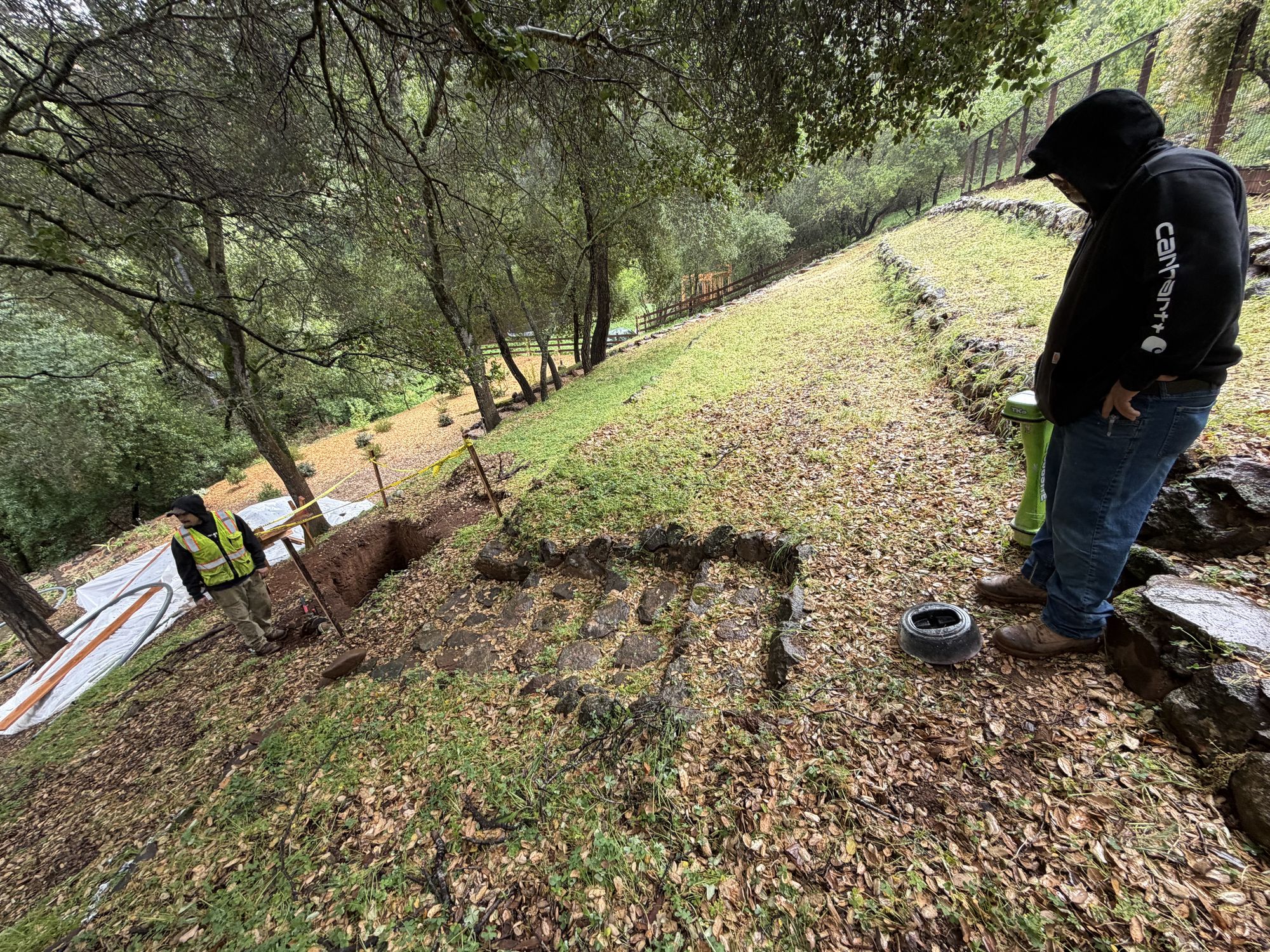 Two exit pits laid out on the wooded hillside