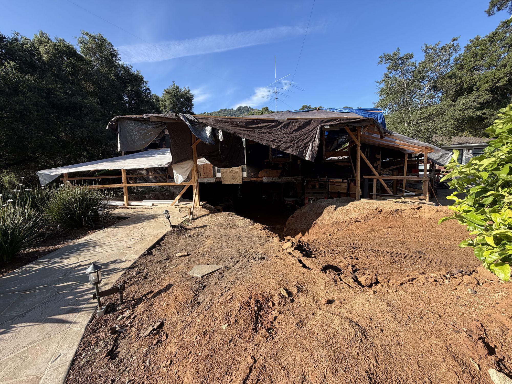 House raised on cribbing with the basement excavated below