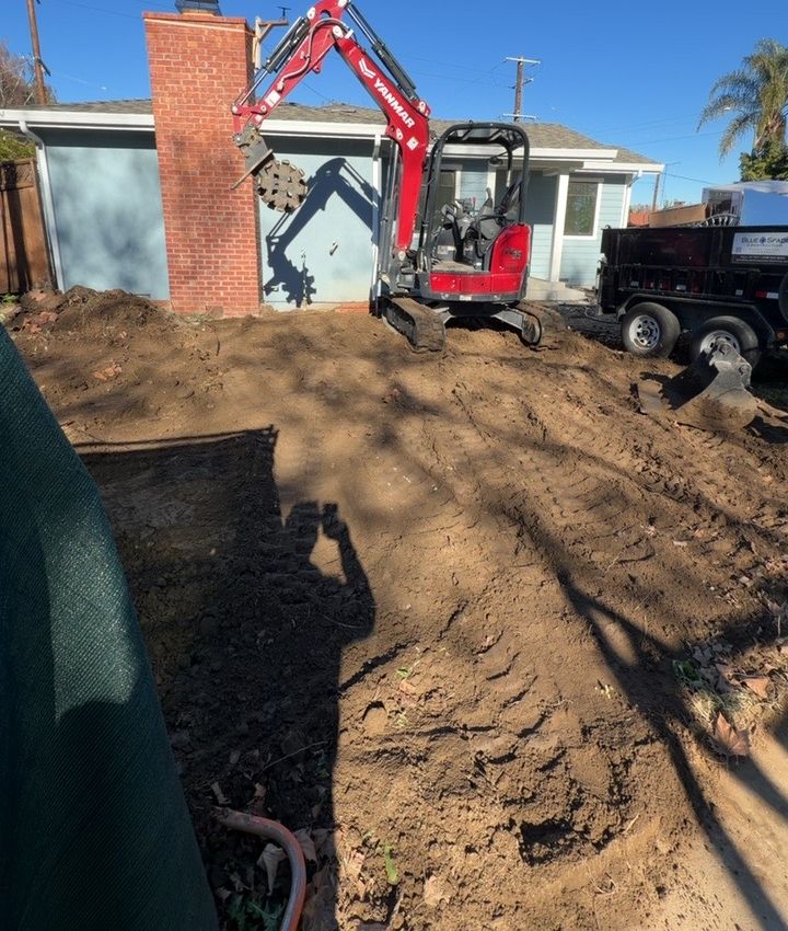 Yanmar ViO35 mini excavator with compaction wheel working at a residential job