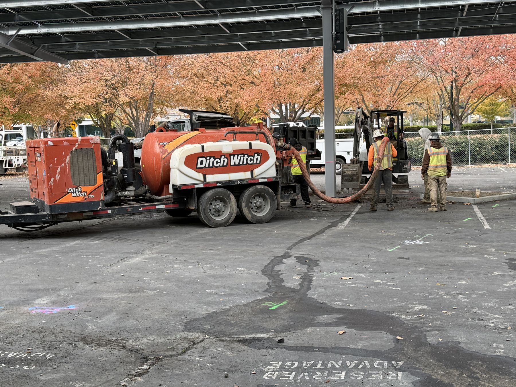 Ditch Witch hydro excavation truck working under solar canopies