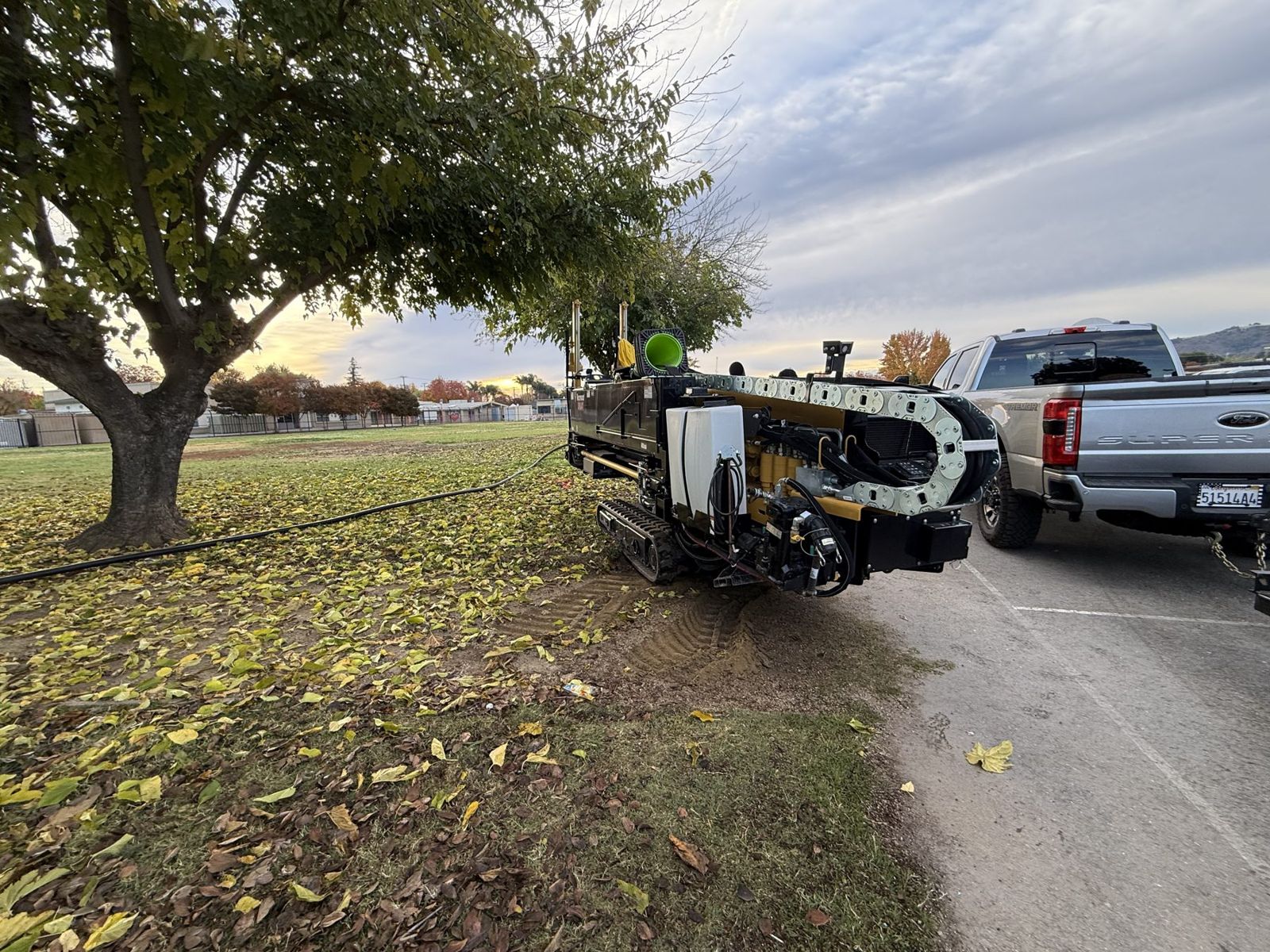 Compact drill set up on a school lawn under a tree