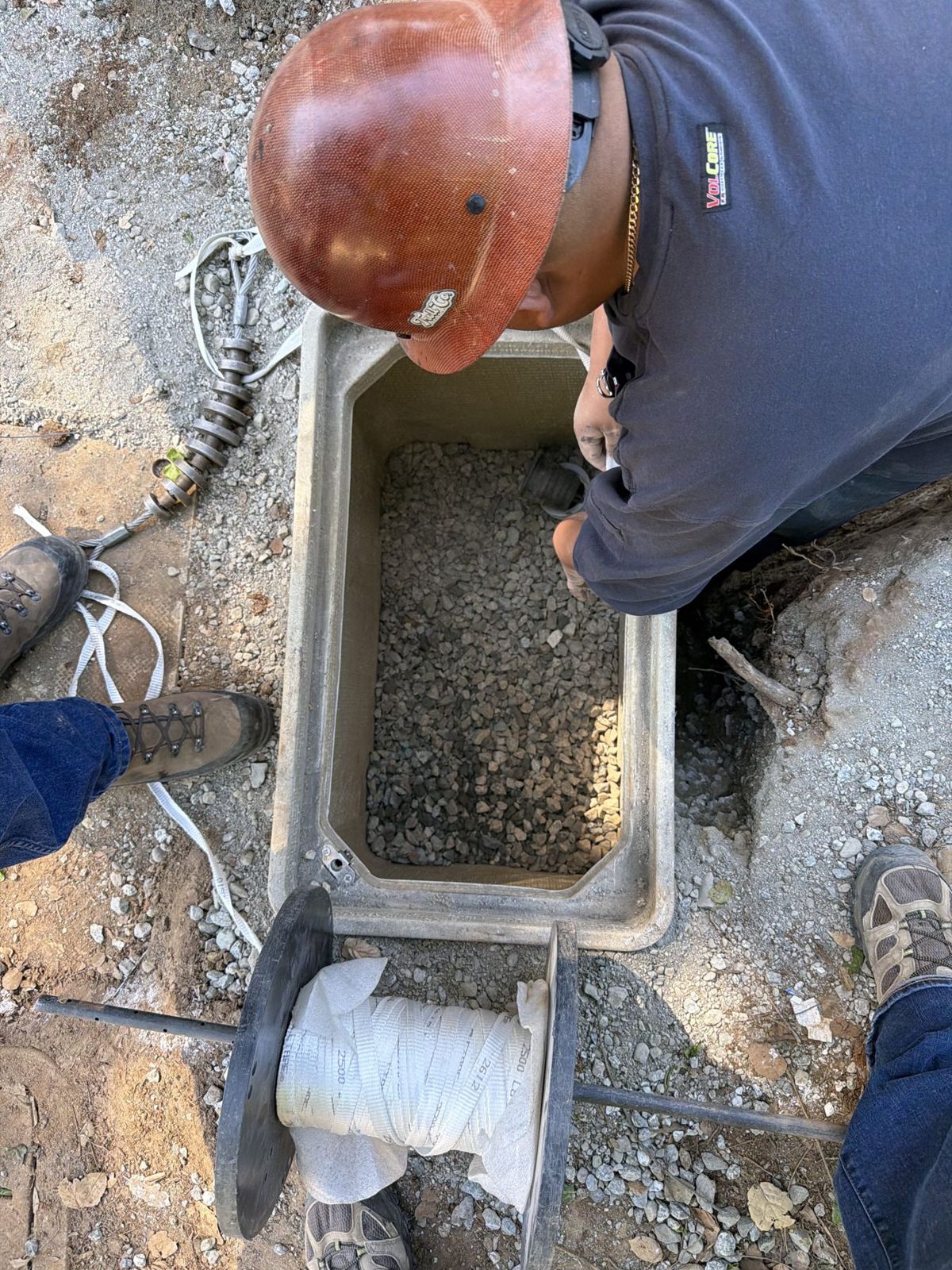 Crew setting a utility pull box with pull rope