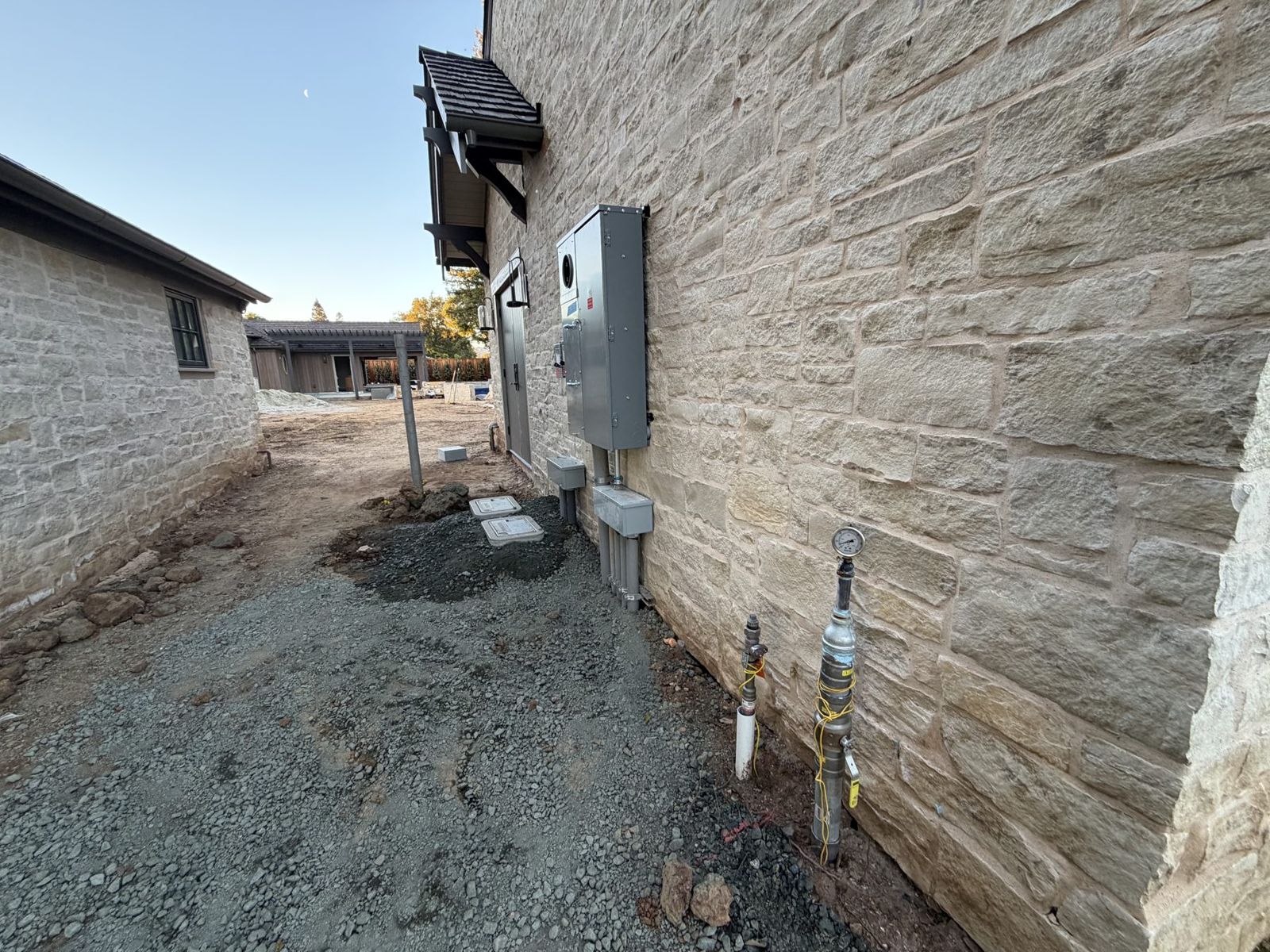 Narrow side yard between a house and a property line where a bore was set up